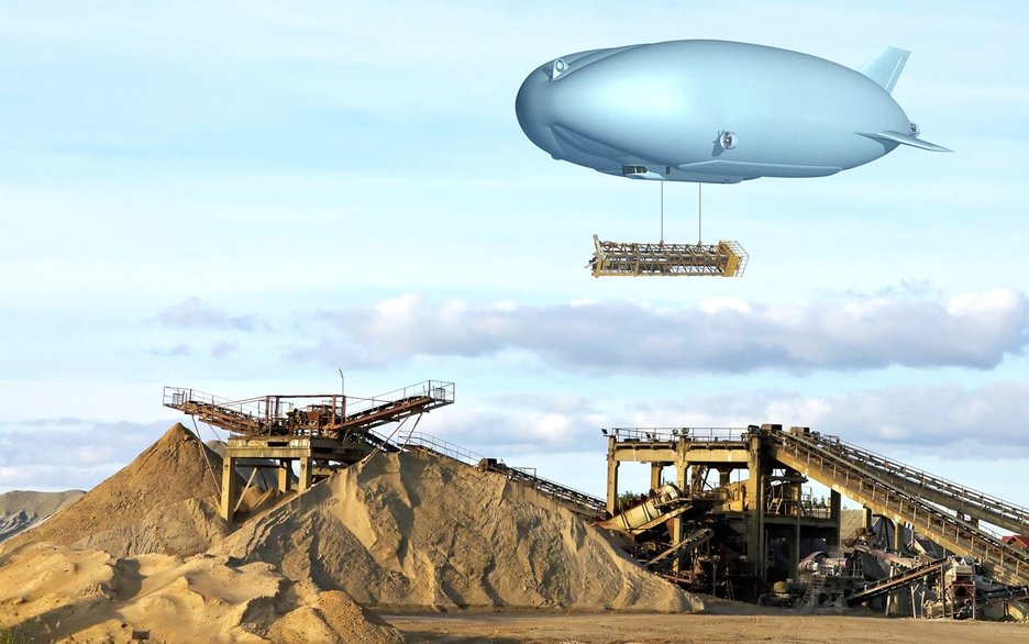 Das Bild zeigt einen Zeppelin, unter dem eine große Last hängt. Dieser schwebt über einer Baustelle in unwegsamem Gelände, an der gerade eine Brücke entsteht. Der Lasten-Zeppelin kann Teile mit bis zu neunzig Tonnen Gewicht heben. Link zum Artikel.